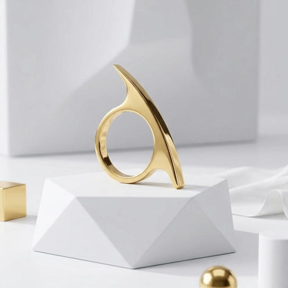 BEHI MILANO Leena Ring — gold statement ring positioned vertically on white display block