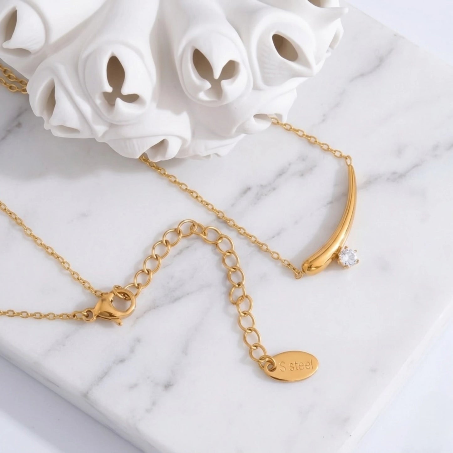 BEHI MILANO Lena Necklace — gold zircon pendant necklace with white ceramic floral decor