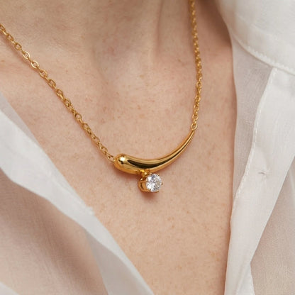 BEHI MILANO Lena Necklace — close-up of model wearing gold zircon crescent horn necklace on neckline