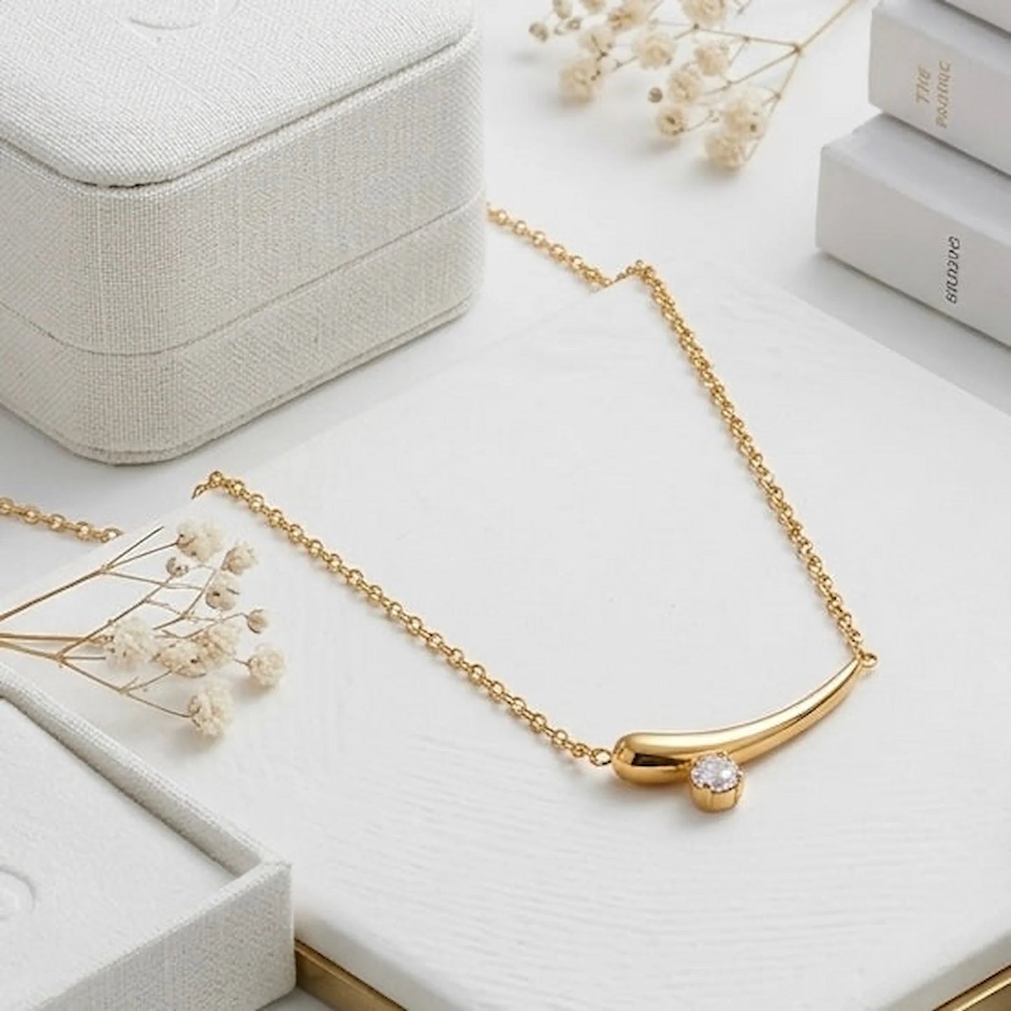 BEHI MILANO Lena Necklace — gold zircon horn necklace on white studio pedestal