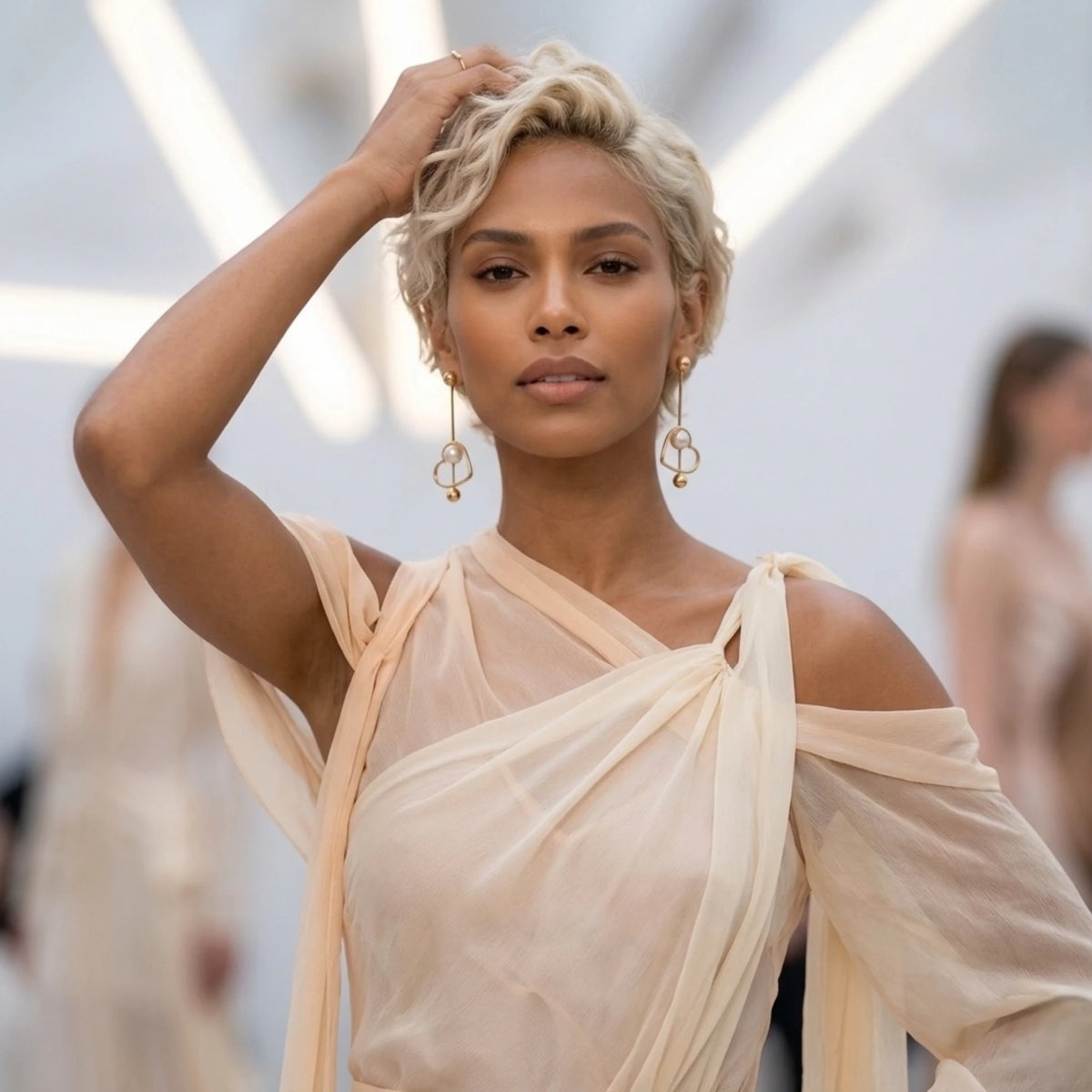 BEHI MILANO Leona Earrings — side profile of model wearing gold heart pearl drop earrings