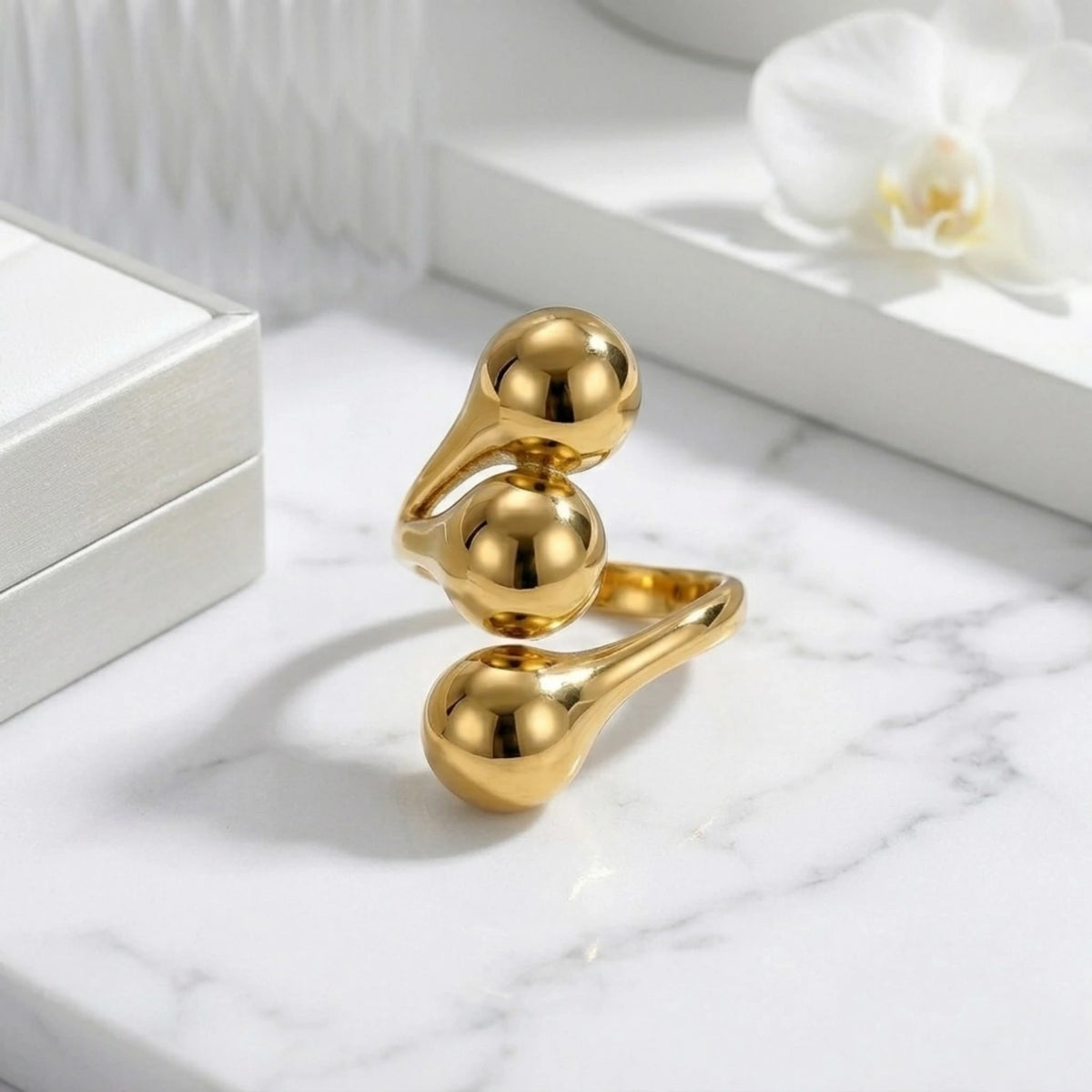 BEHI MILANO Letiz Ring — gold molten bypass ring on white marble surface