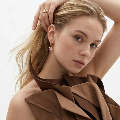 BEHI MILANO Lidia Earrings — model wearing gold pink zircon heart hoop earrings