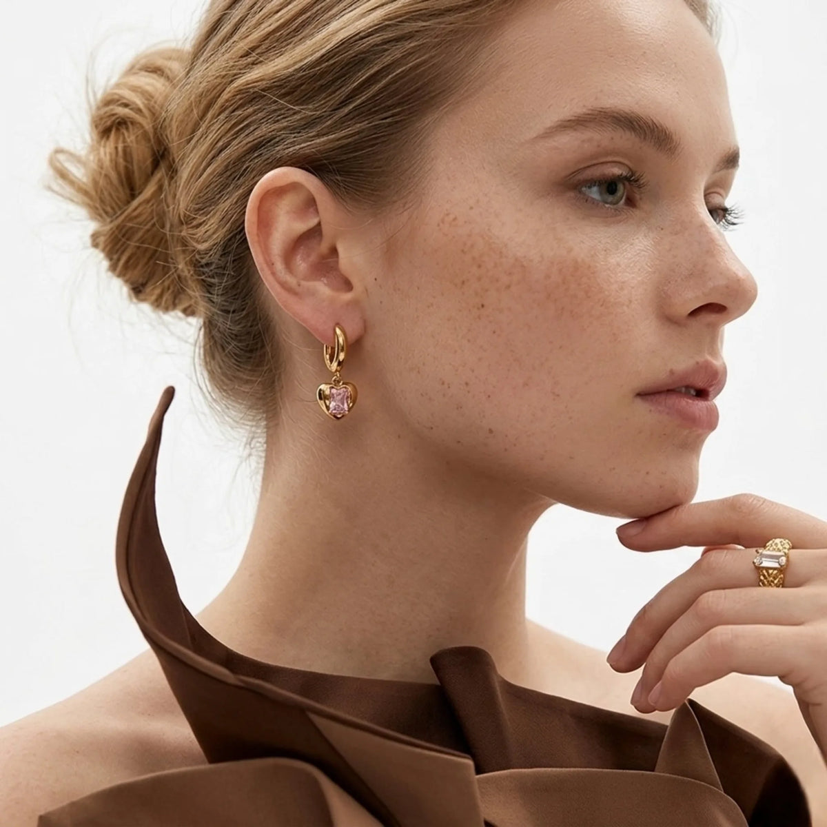 BEHI MILANO Lidia Earrings — model side profile wearing gold pink zircon heart drop earrings