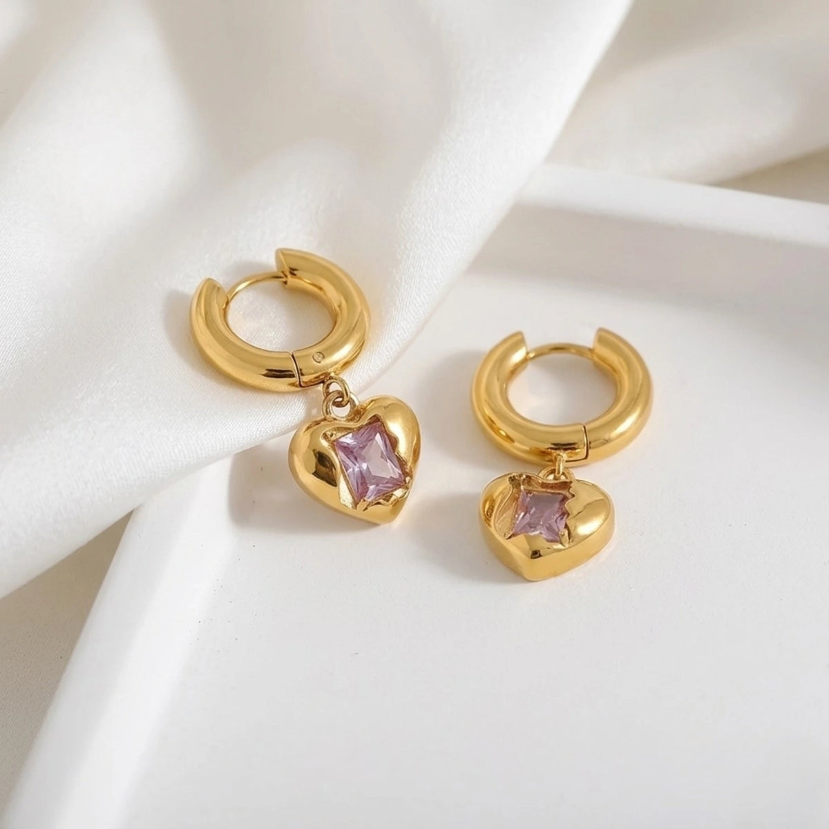 BEHI MILANO Lidia Earrings — gold pink zircon heart drop earrings styled on white marble display