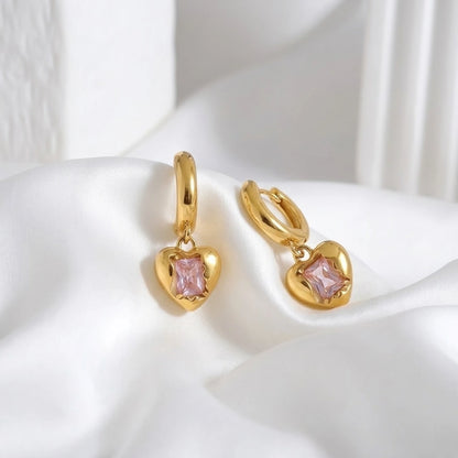BEHI MILANO Lidia Earrings — gold heart charm hoop earrings on soft white silk fabric
